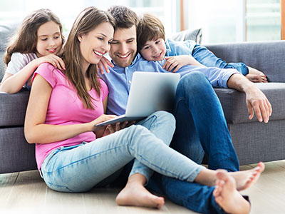 Young happy family on a computer